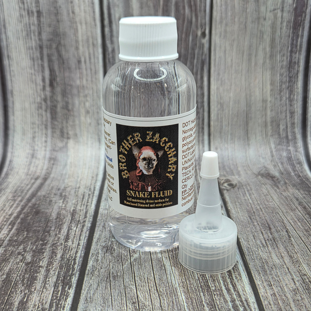 Bottle of Brother Zacchary’s Snake Fluid™ lap lubricant with applicator nozzle