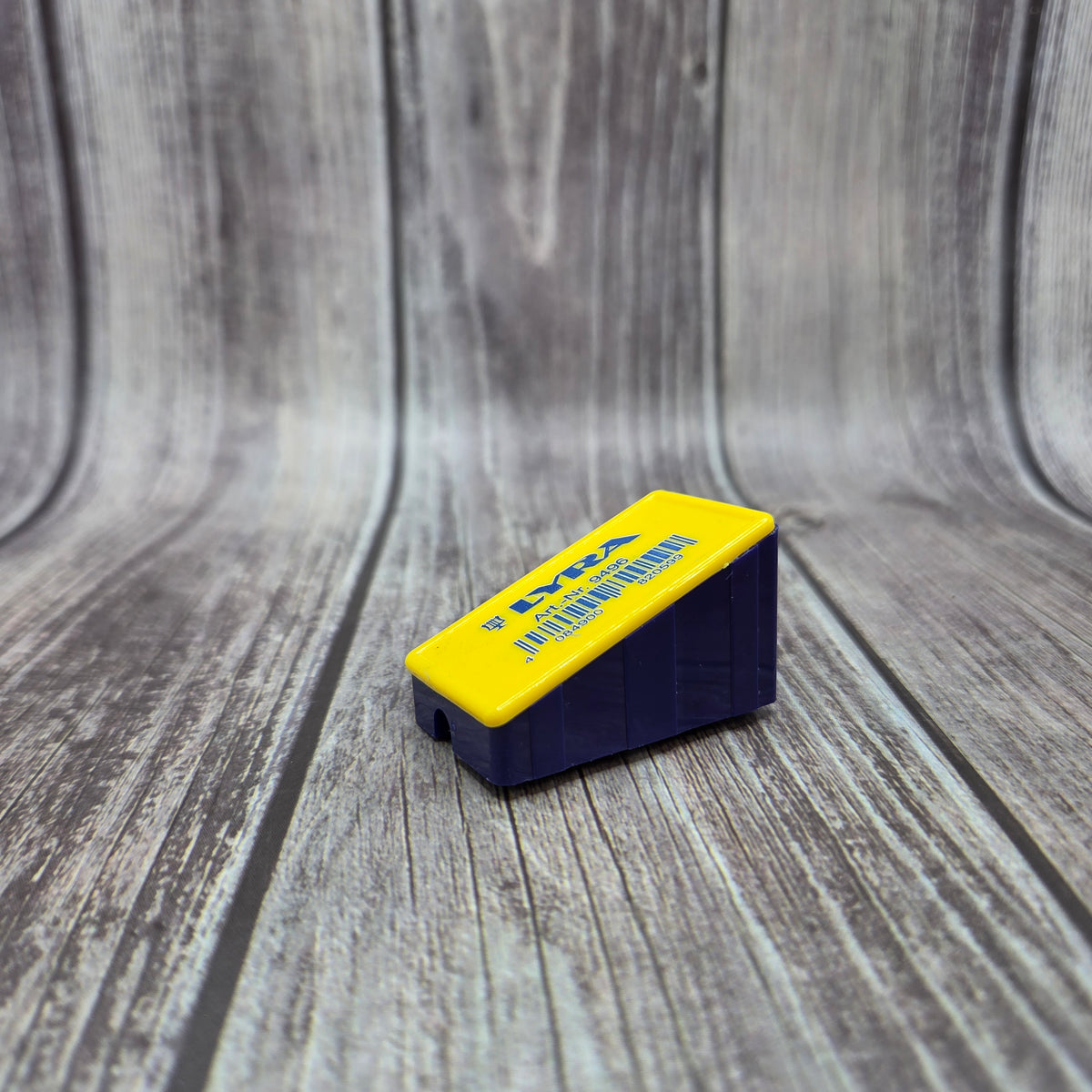 Yellow and navy BATTSTIK™ Sharpener shown from the front and side