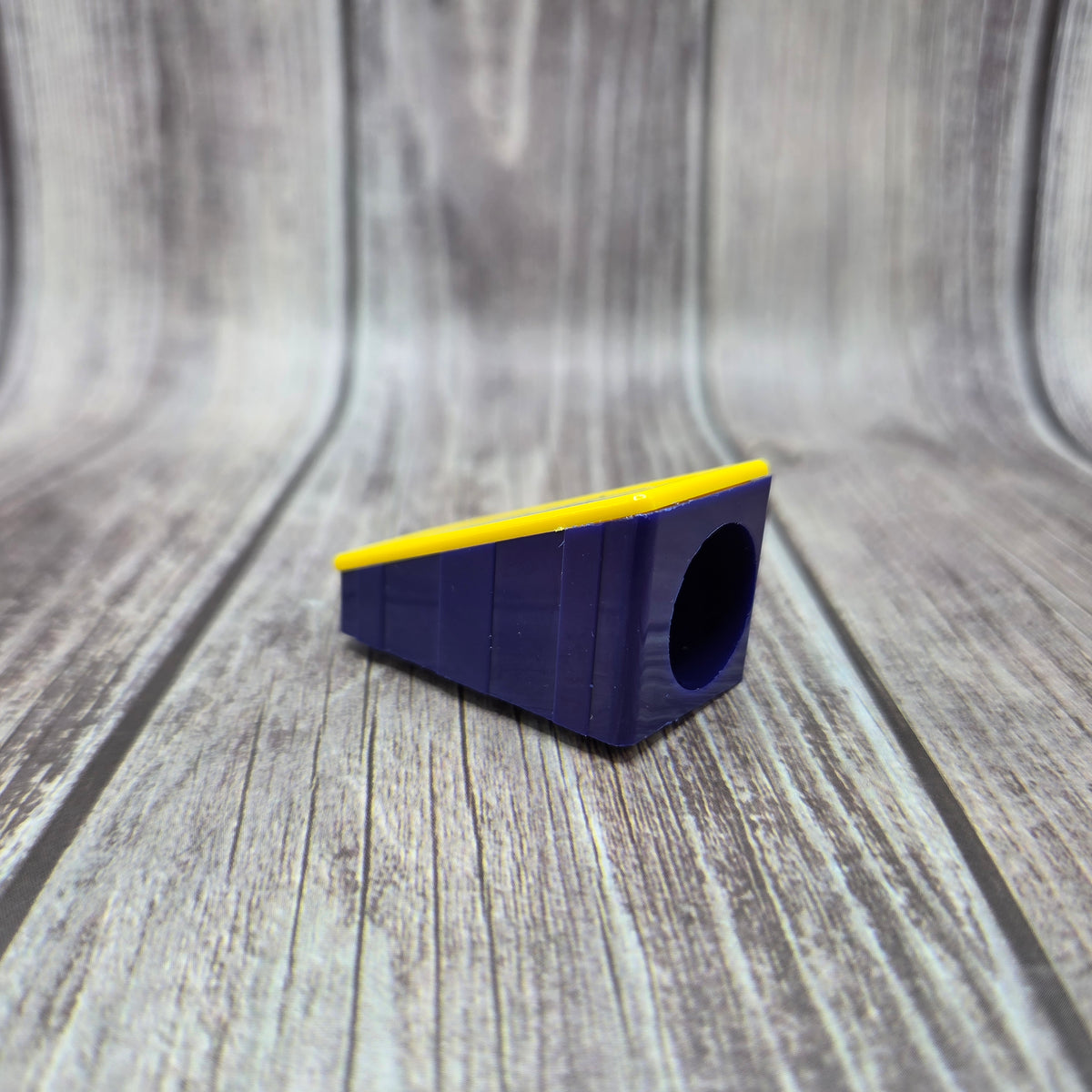Side view of the BATTSTIK™ Sharpener showing the opening and yellow top