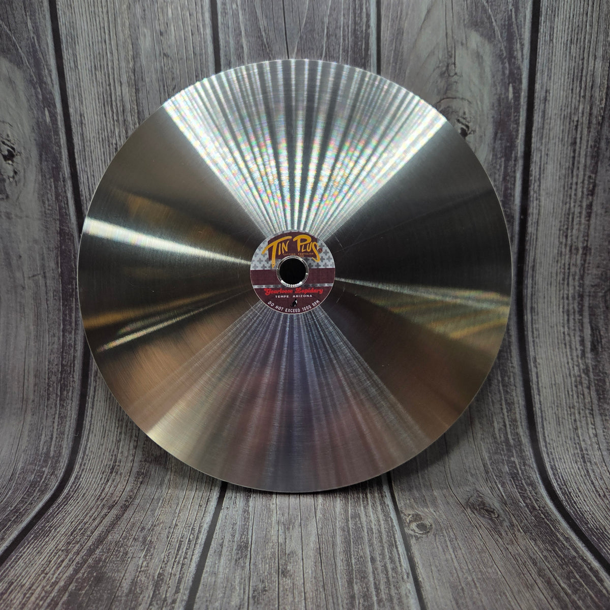 TIN PLUS™ laminated tin-alloy faceting lap shown upright with its polishing surface and center label visible